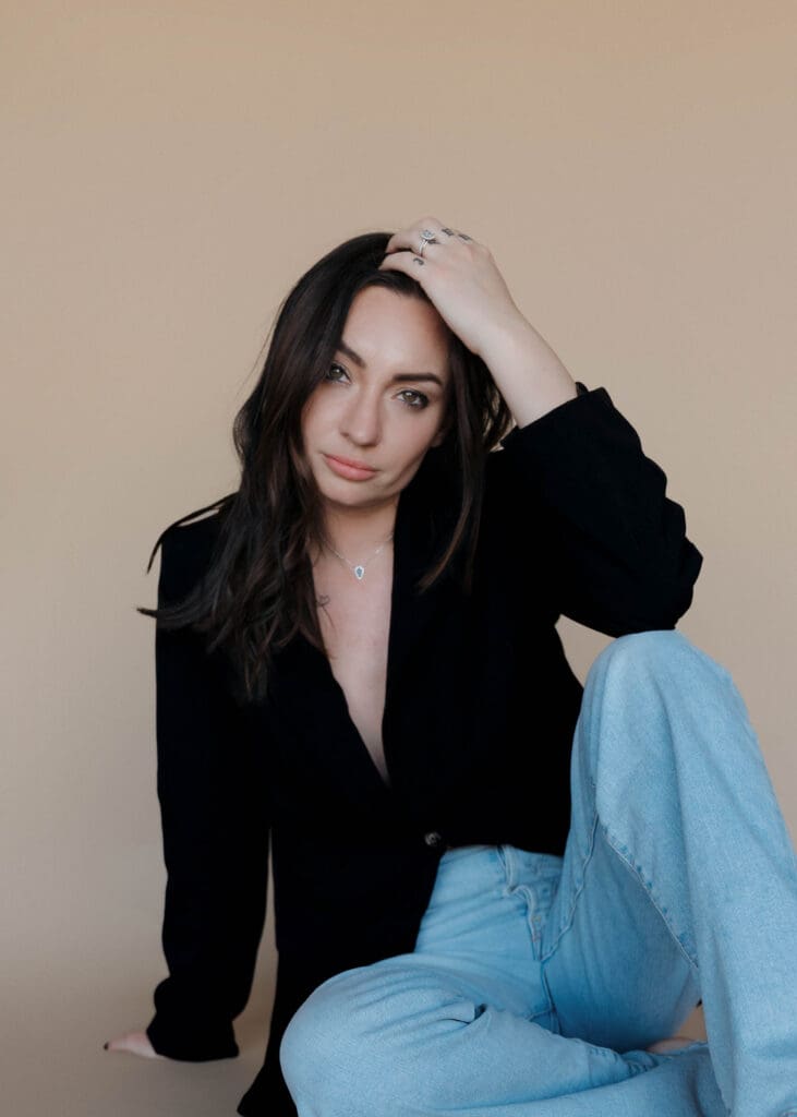 a female photographer poses for her headshot 