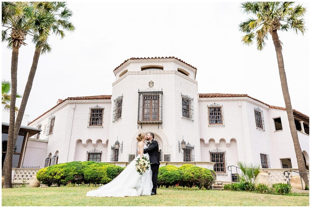 A bride and groom pose for their wedding day photos at The McNay Art Museum in San Antonio, Texas